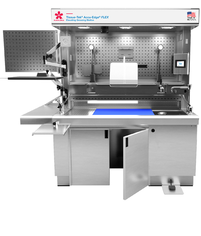 A stainless steel laboratory workstation with an illuminated working area, storage compartments, shelves, and integrated equipment for tissue processing and dissection.
