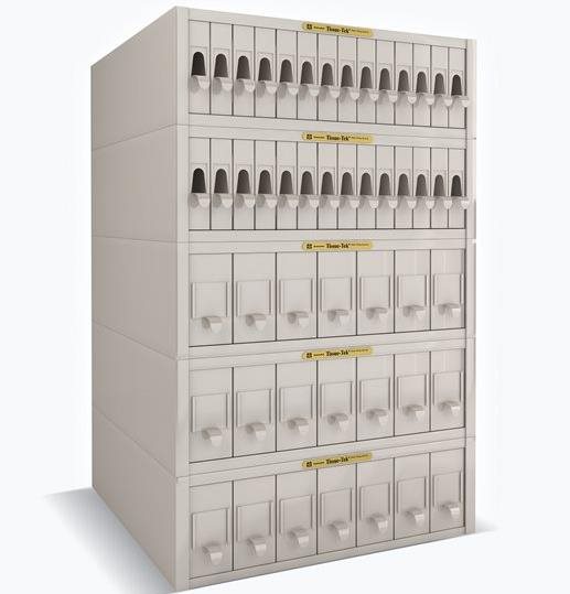 A large, multi-tiered white locker unit with numerous labeled compartments and individual handles or slots on each door.