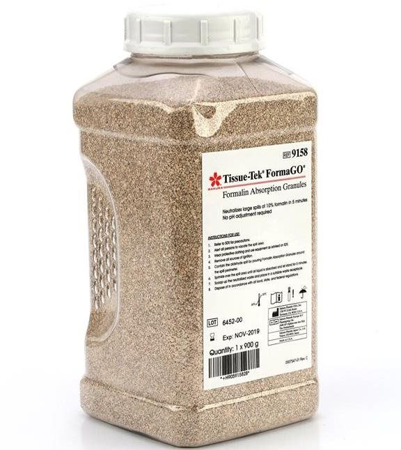 A large plastic container labeled “Tissue-Tek FormaGO Formalin Absorption Granules” filled with beige granules, used for absorbing formalin in laboratory settings.