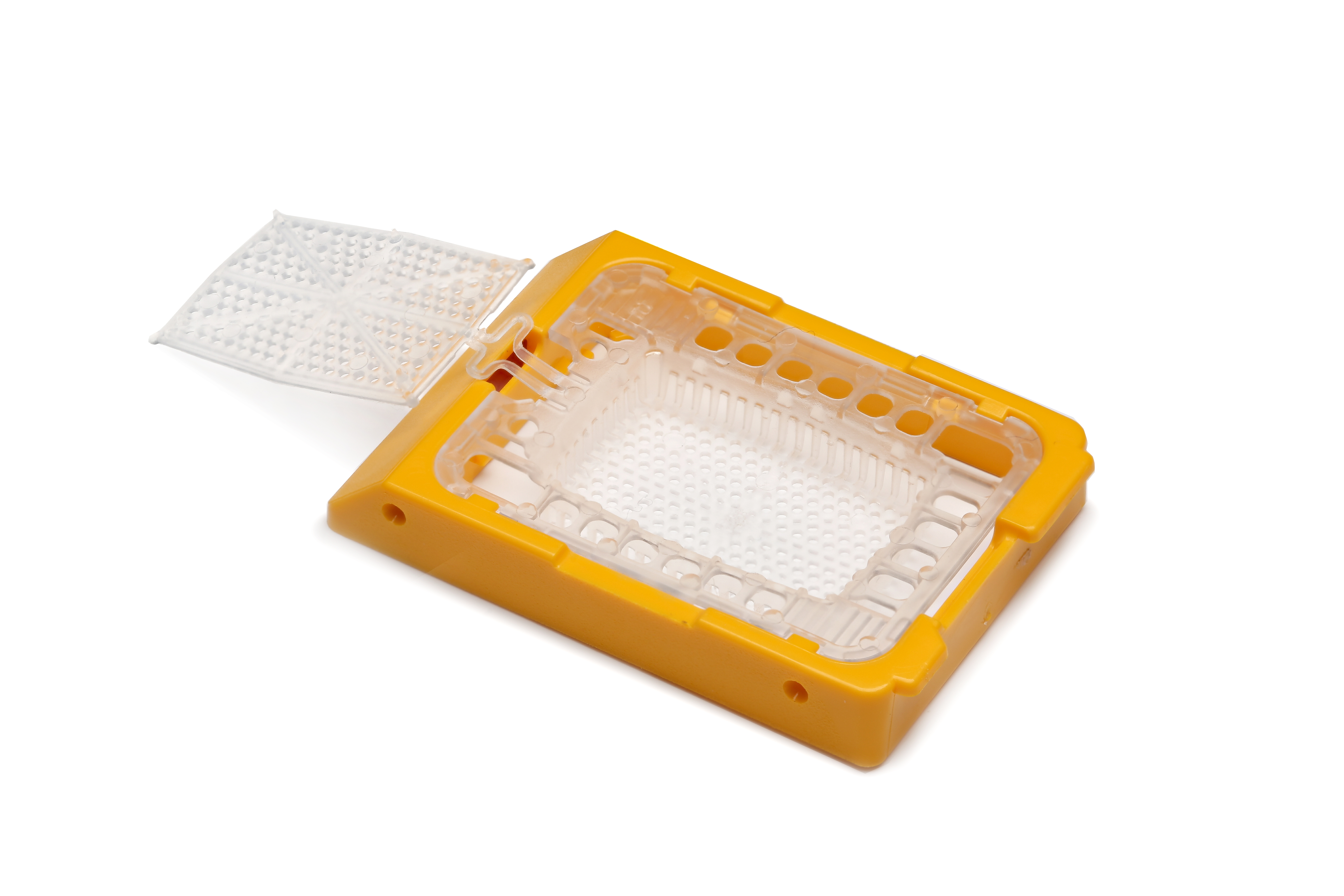 A yellow and white plastic biopsy cassette with a hinged lid, used for holding tissue samples in medical laboratories, is shown on a white background.