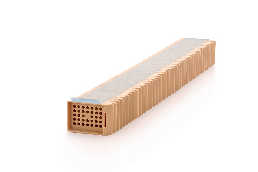 A rectangular beige honeycomb ceramic filter block with a perforated front, seen on a white background.