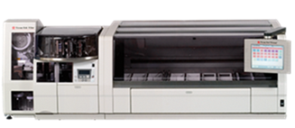 Large automated laboratory analyzer with a touchscreen display, sample trays, and compartments for medical or scientific testing.