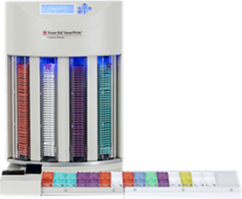 A medication dispensing machine with multiple vertical columns containing different colored compartments and a removable tray at the bottom.