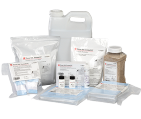 A collection of laboratory chemical reagents in various containers including bottles, bags, and a jug, all labeled with product information.
