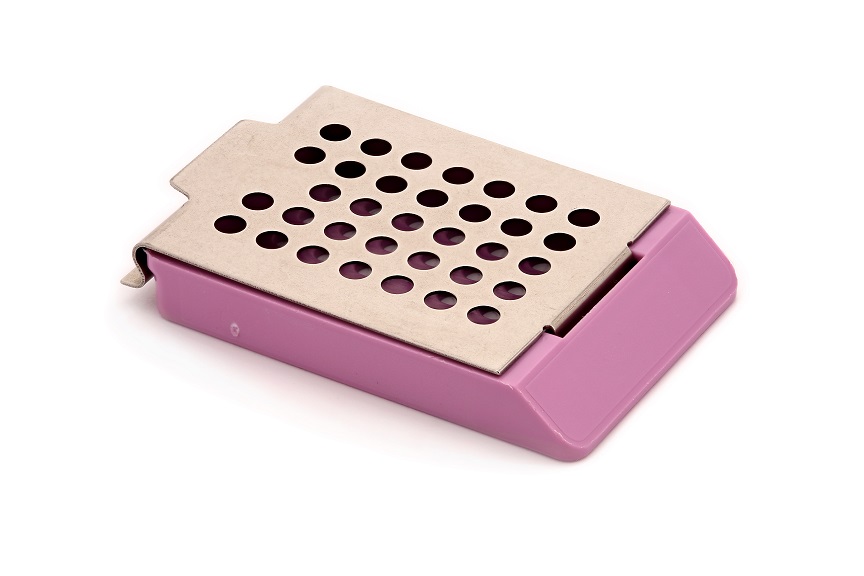 A small, rectangular, purple and silver metal container with circular holes on the lid, placed on a white background.