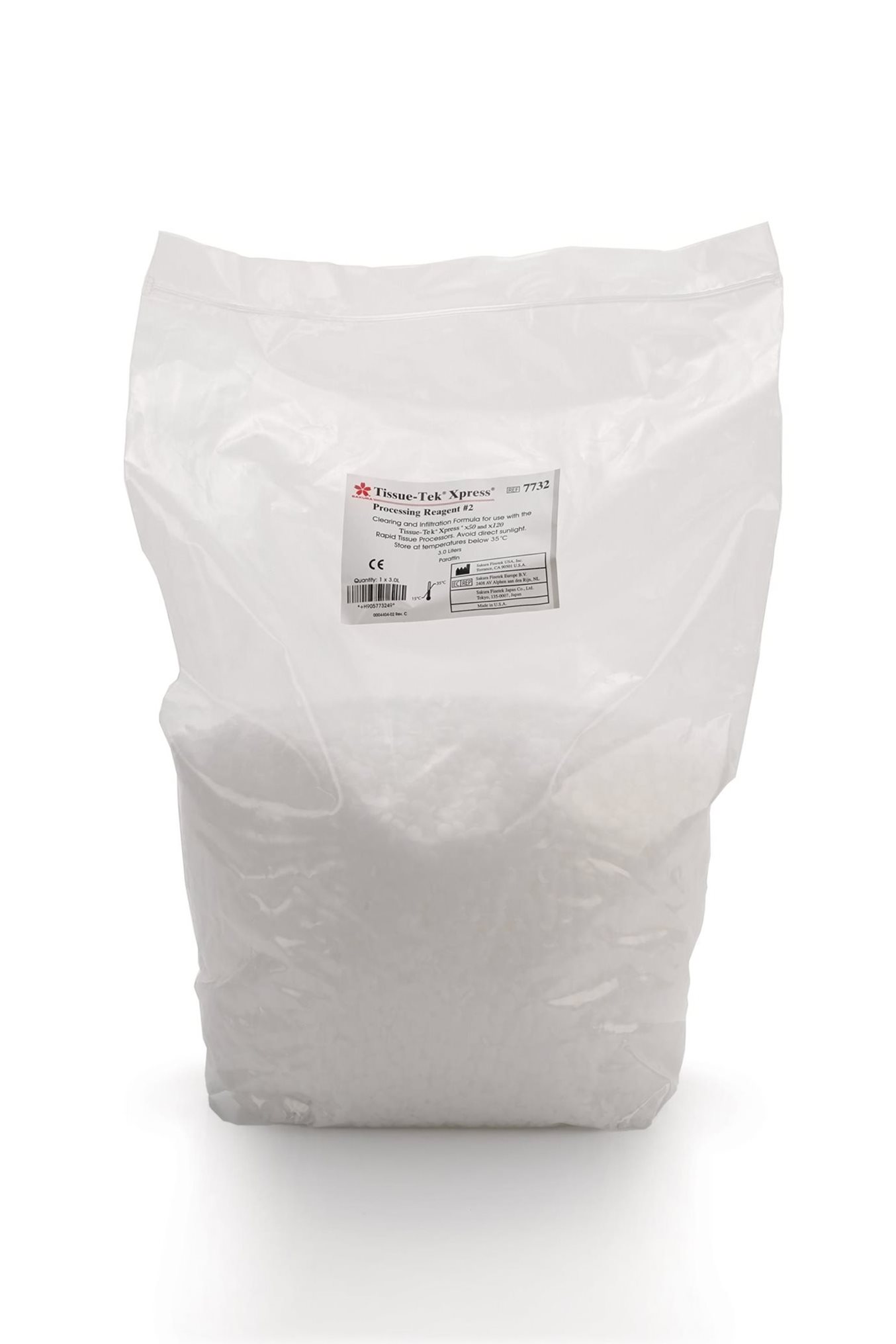 A clear plastic bag filled with white pellets, featuring a label with product and company information on the front.