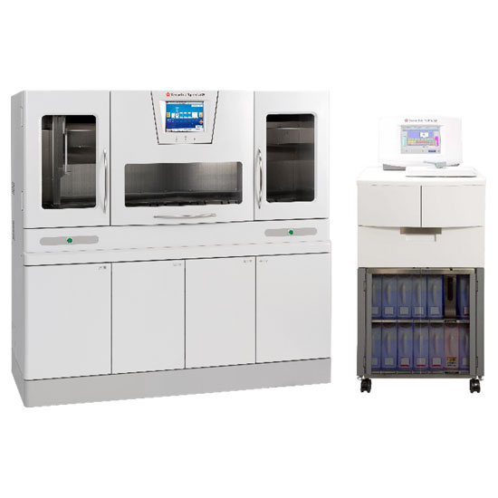 Two laboratory machines: a large, multi-door analyzer with a touchscreen display on the left, and a smaller unit with storage compartments and a screen on the right.