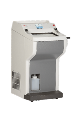 A white laboratory cryostat machine with control buttons on top and a container positioned in the lower compartment.