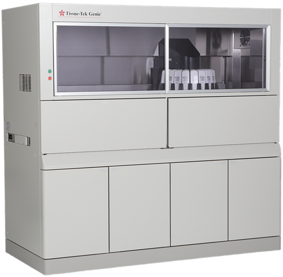 A laboratory instrument labeled "Tissue-Tek Genie" with a glass front panel, internal sample holders, and multiple storage compartments below.