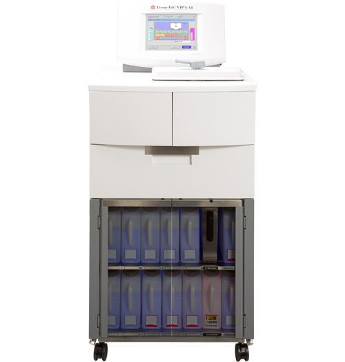 A medical dispensing cabinet with a touchscreen interface on top and multiple medication bins visible behind a transparent door at the bottom.