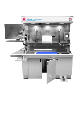 Stainless steel laboratory workstation with overhead lighting, pegboard, monitor, blue work mat, side shelf, and open lower cabinets.